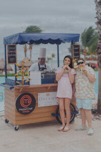 Master Chef Junior Participants Ivy Childs and Bryson McGlynn sample marquesitas at the Master Chef Junior Pool Party and Pop Up at Dreams Natura Resort