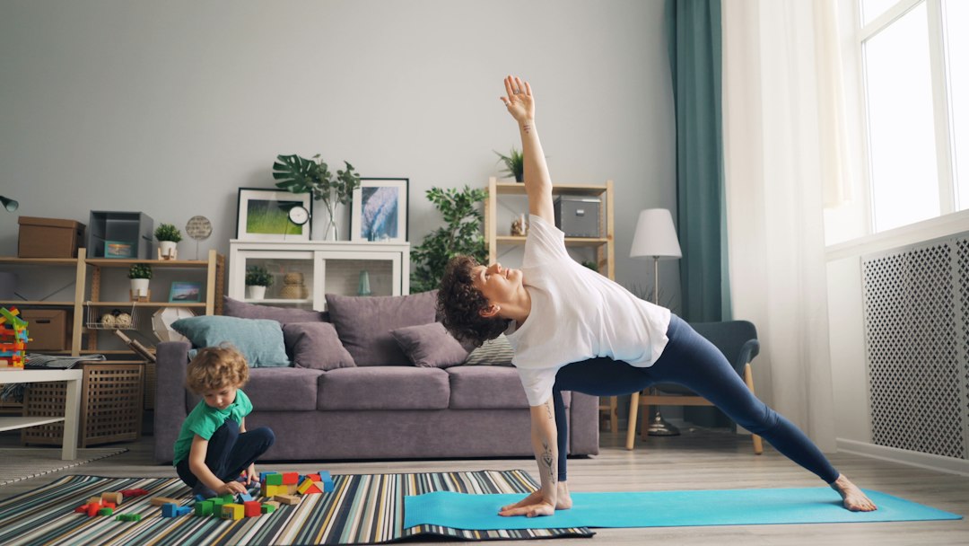mother peacefully practicing yoga at home - coping with mom guilt mother peacefully practicing yoga at home - coping with mom guilt