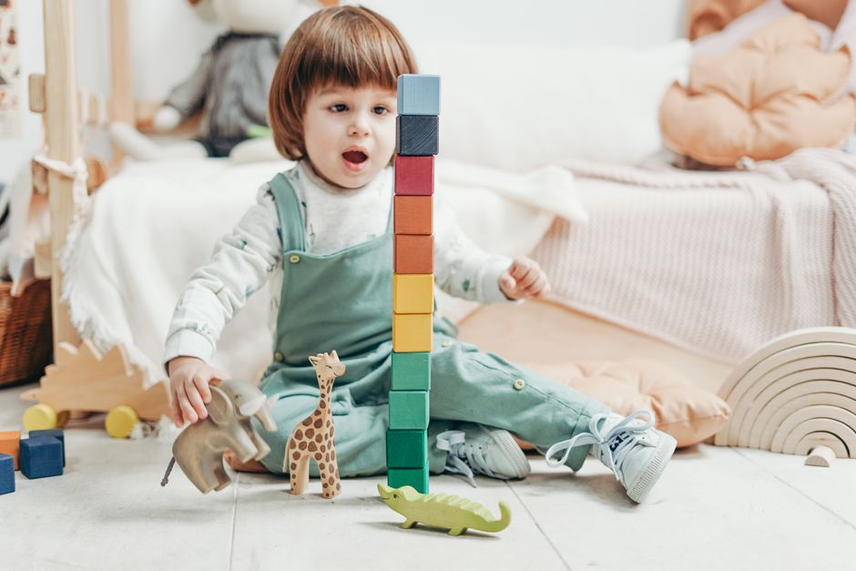 Child playing happily with a small selection of blocks - Decluttering with kids Child playing happily with a small selection of blocks - Decluttering with kids