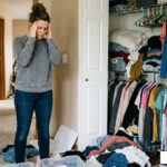 decluttering decision fatigue woman overwhelmed by cluttered closet - Decluttering decision fatigue