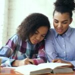 college admissions process mother and teenager looking at laptop together