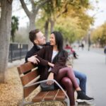 couple sitting on a park bench talking reconnecting after a relationship break