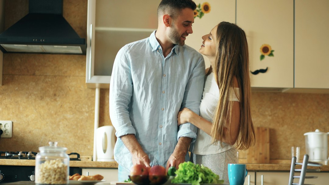 couple cooking together in kitchen