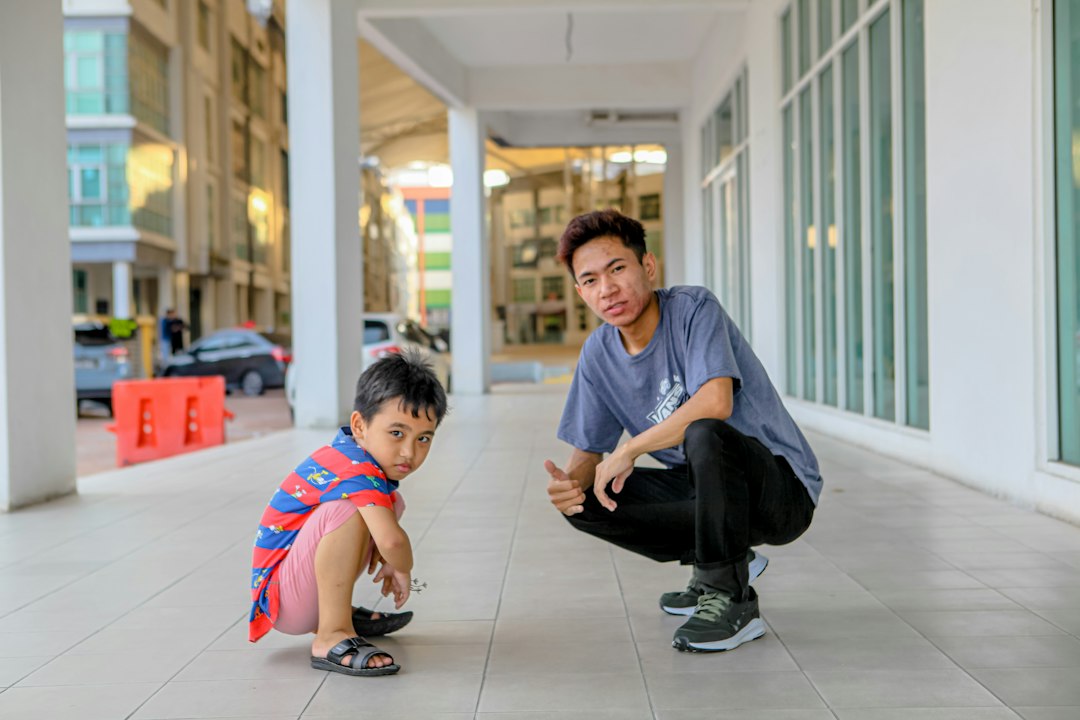 Parent kneeling to make eye contact with a young child Parent kneeling to make eye contact with a young child